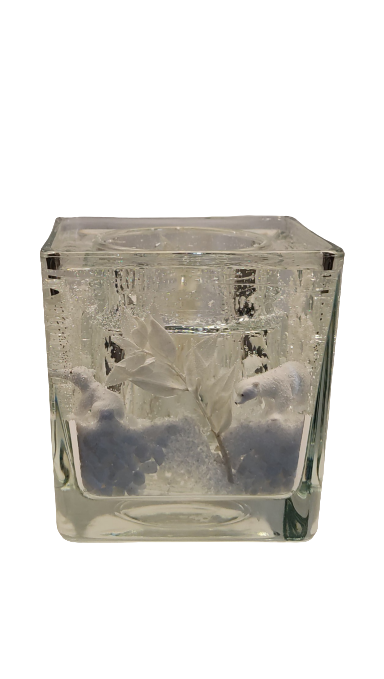 Photophore en verre transparent avec ours polaires et effet neige, créant une ambiance hivernale féerique.