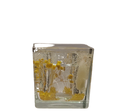 Photophore Douceur d'Or en verre transparent avec fleurs jaunes et particules scintillantes.